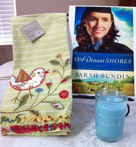 Georgie's Giveaway Bundle: Appliqued Tea Towel,  "Mediterranean"-scented candle, and a copy of On Distant Shores once it's available.